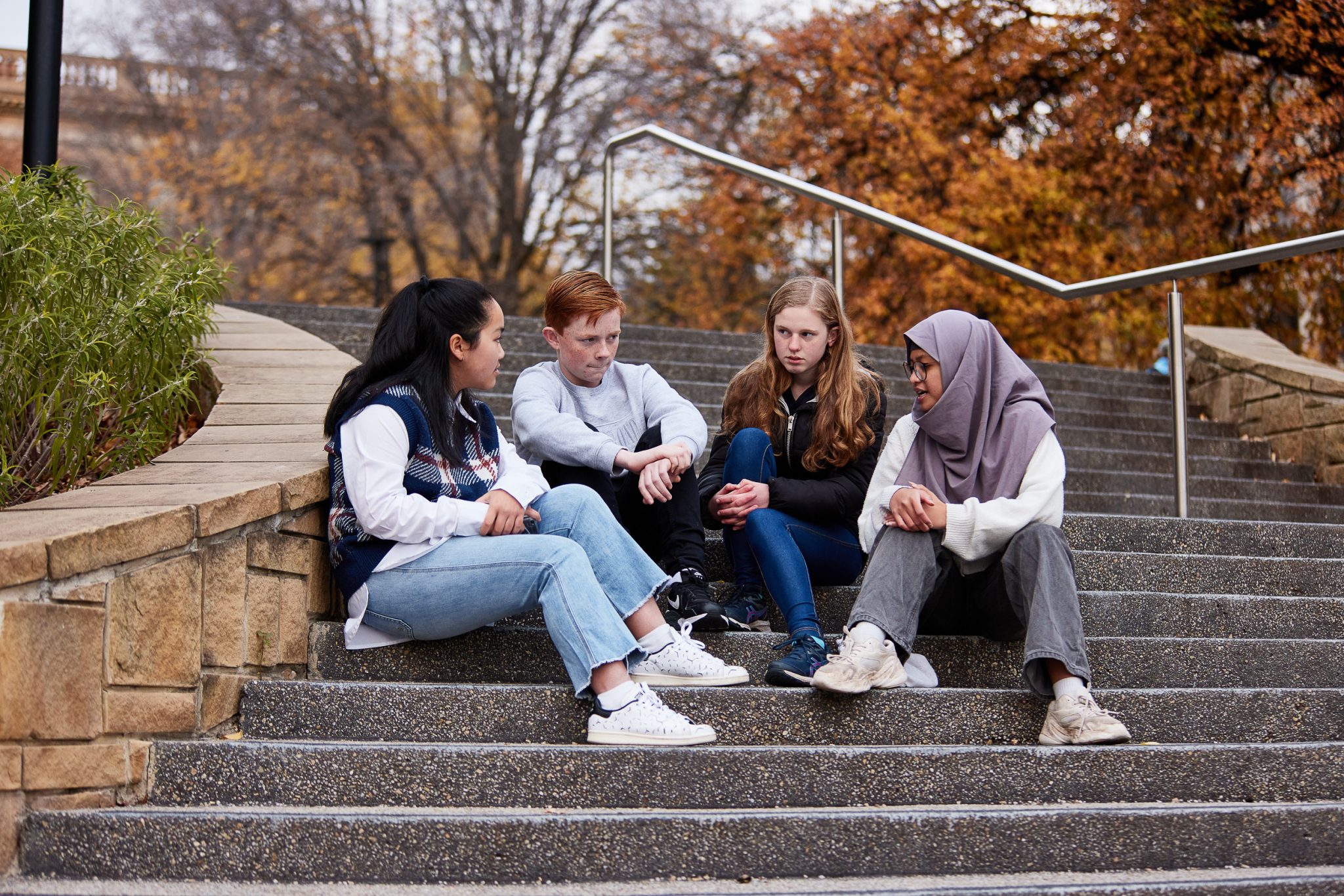 Image of young people sitting on steps and talking